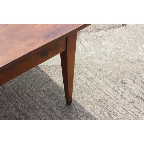 541 - A 19th century French cherrywood farmhouse dining table, fitted one frieze drawer, on square taper s... 