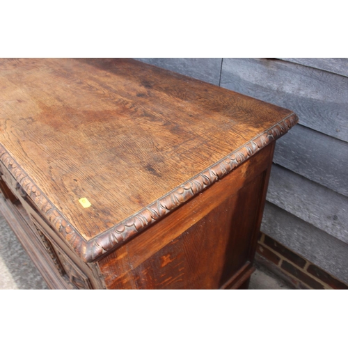 546 - A carved oak sideboard of 17th century design, fitted two long drawers, over central small drawer an... 