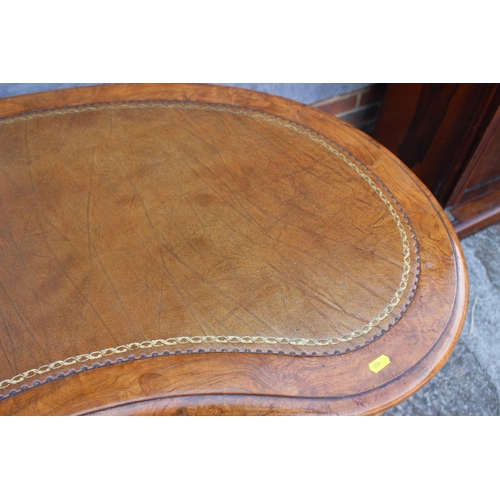 556 - A late 19th century figured walnut kidney-shaped double pedestal desk with tooled leather lined top,... 