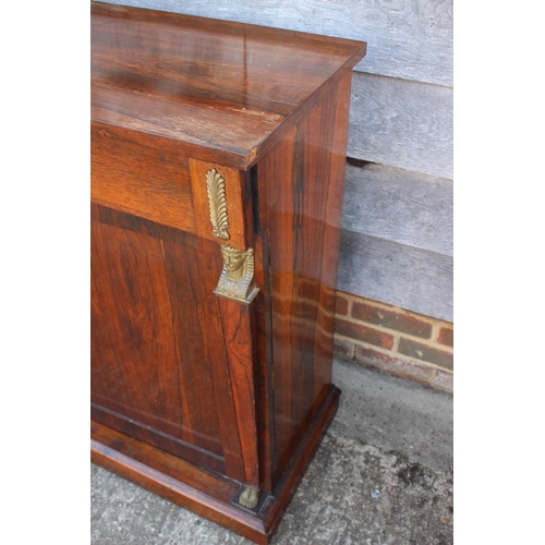 559 - A 19th century rosewood chiffonier, fitted freeze drawer, over cupboards flanked by Egyptian herms, ... 