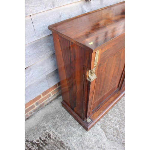 559 - A 19th century rosewood chiffonier, fitted freeze drawer, over cupboards flanked by Egyptian herms, ... 