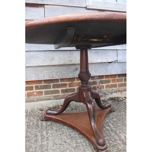 562 - An early 19th century pollard oak single-piece circular tilt top table, on vase turned mahogany colu... 