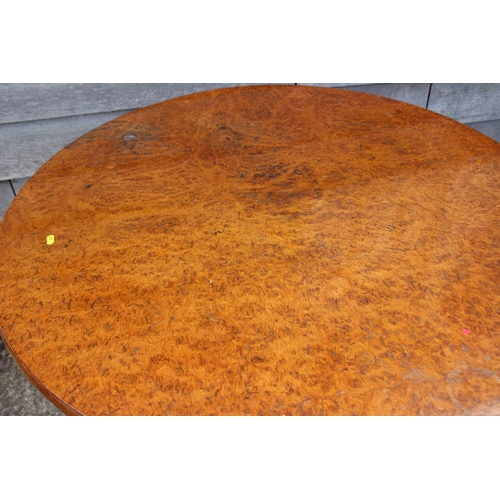 562 - An early 19th century pollard oak single-piece circular tilt top table, on vase turned mahogany colu... 