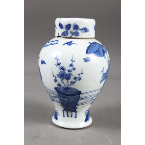 57 - A Chinese blue and white vase with matched lid, with figure and urn decoration, 6 1/4