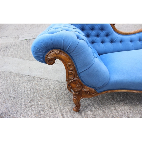 573 - A late 19th century shape-back chaise longue, button upholstered in a blue fabric, on cabriole casto... 