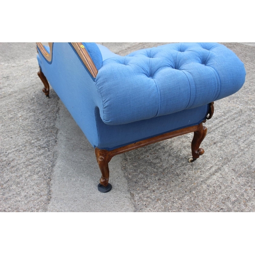 573 - A late 19th century shape-back chaise longue, button upholstered in a blue fabric, on cabriole casto... 