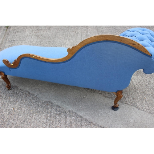 573 - A late 19th century shape-back chaise longue, button upholstered in a blue fabric, on cabriole casto... 