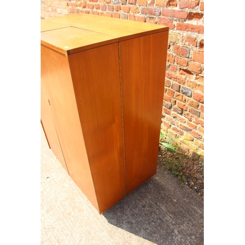 590 - A 1960s teak home office cabinet with fitted interior, pull-out writing surface, adjustable lamp, sh... 