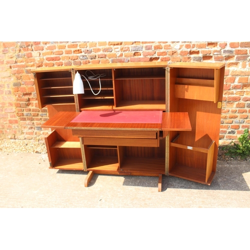 590 - A 1960s teak home office cabinet with fitted interior, pull-out writing surface, adjustable lamp, sh... 