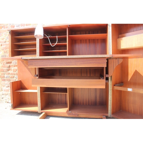 590 - A 1960s teak home office cabinet with fitted interior, pull-out writing surface, adjustable lamp, sh... 