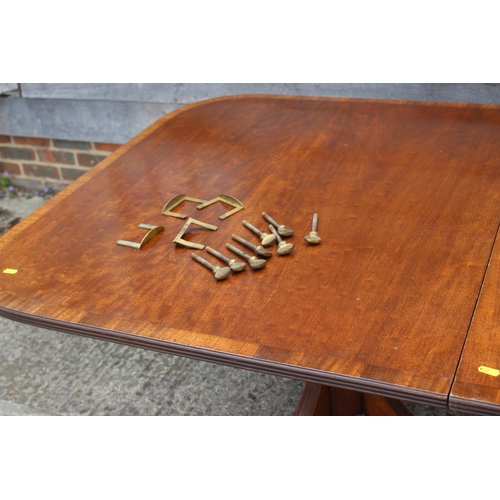 601 - A mahogany double pedestal dining table of Georgian design with one extra leaf, on turned columns an... 