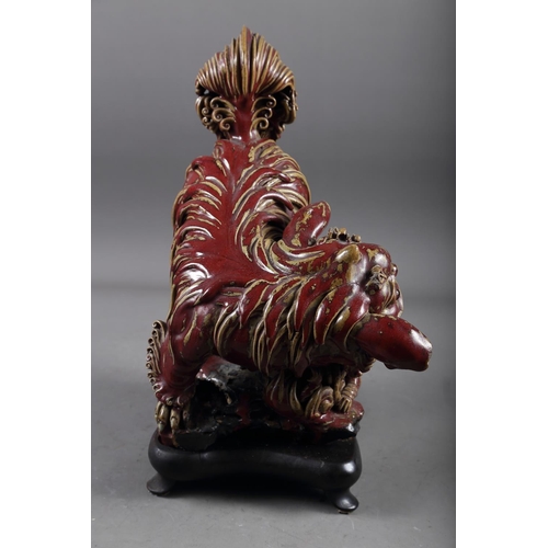 62 - A Chinese red and brown glazed porcelain model of a Dog of Fo, on hardwood stand, 16