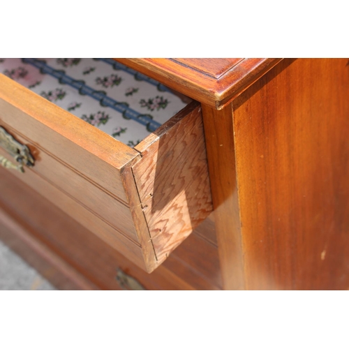 624 - An Edwardian walnut dressing chest, fitted mirror over jewel drawer and three graduated long drawers... 