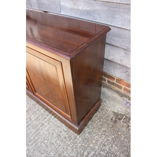 625 - A polished mahogany side cupboard with fitted interior enclosed two panel doors, on block base, 54