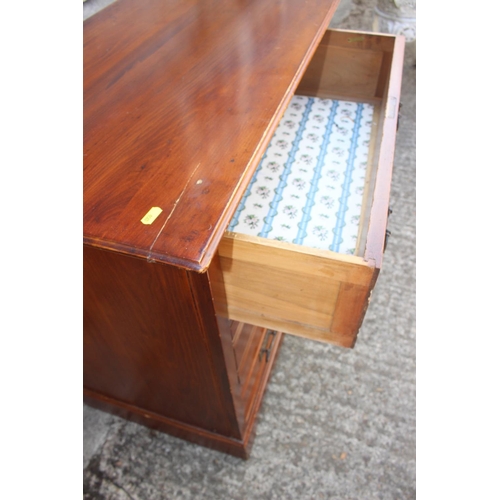 626 - A 1920s walnut chest of three long drawers with anodised handles, on bracket feet, 33