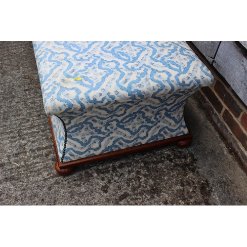 648 - A box Ottoman with concave sides and padded top, upholstered in a blue floral fabric, on ball feet, ... 