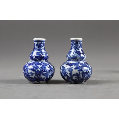 67 - A Chinese blue, white and iron oxide glazed cylindrical miniature vase with warriors in a landscape ... 