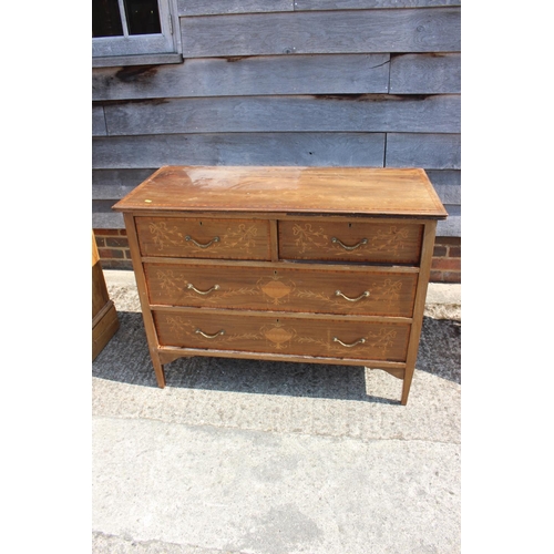 673 - An Edwardian mahogany and inlaid dressing chest of three long drawers, on square taper supports, 42