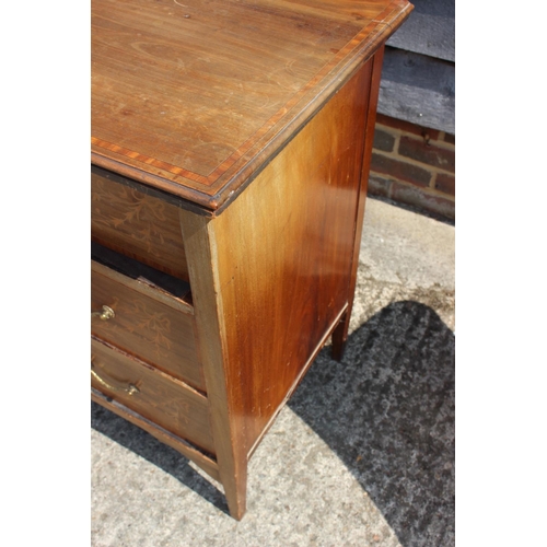 673 - An Edwardian mahogany and inlaid dressing chest of three long drawers, on square taper supports, 42