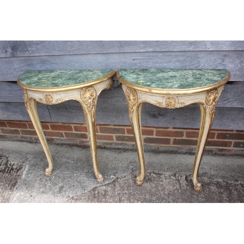 675 - A pair of giltwood demi-lune marble effect console tables, on cabriole supports, 25 1/2