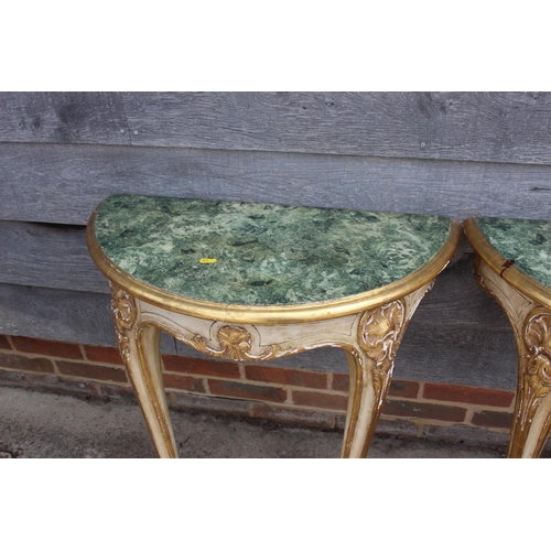 675 - A pair of giltwood demi-lune marble effect console tables, on cabriole supports, 25 1/2