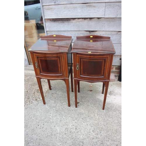 678 - A pair of Edwardian mahogany and kingwood banded bowfront bedside cupboards, on square taper support... 