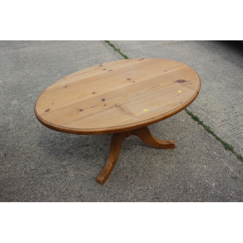 680 - A waxed pine, oval, low occasional table, on turned column and tripod splay support, 42