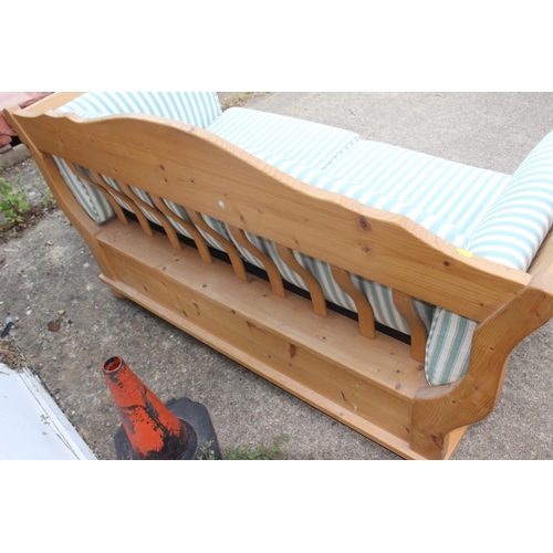 681 - A waxed pine two-seat showframe settee, fitted two drawers and loose cushions, on bun feet, 52