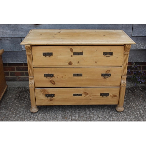 693 - A 19th century Continental waxed pine chest of three long graduated drawers, 42