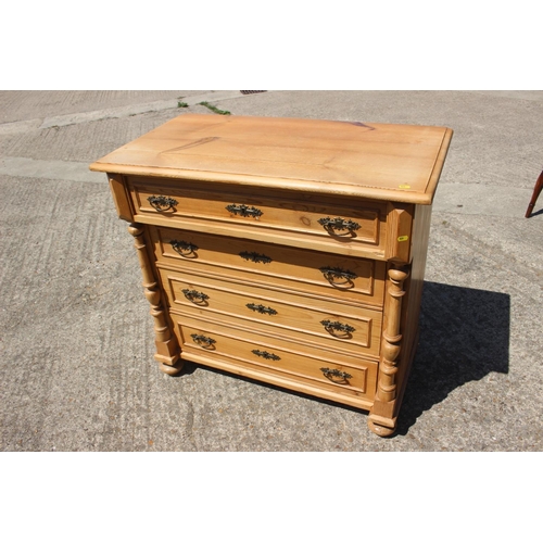 694 - A 19th century Continental waxed pine chest of four long drawers with brass handles, 38