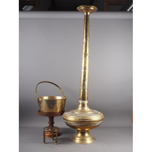 107 - An embossed brass vase with long tapering neck and bulbous body, 42