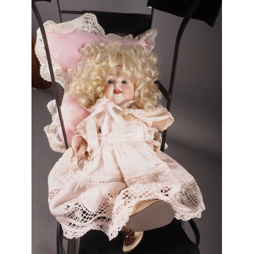 133 - A German porcelain headed doll, 12