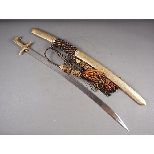 143 - A Middle Eastern curved dress sword with engraved gilt metal grip and scabbard, inset coloured glass... 