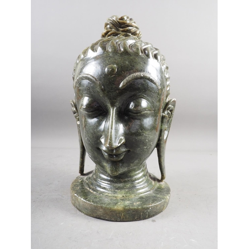 169 - A carved hardstone bust of a deity, on circular base, 12