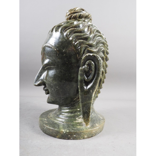 169 - A carved hardstone bust of a deity, on circular base, 12