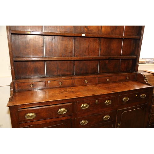 540 - A 19th century oak dresser, the back fitted shelves over five small drawers with three further long ... 