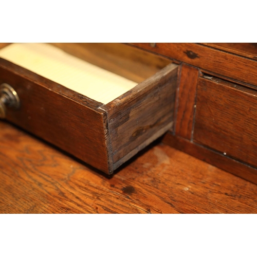 540 - A 19th century oak dresser, the back fitted shelves over five small drawers with three further long ... 