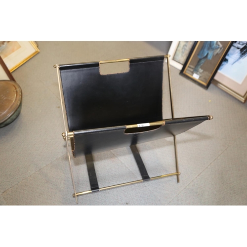 676 - An Asprey's brass and leather folding magazine rack, a brass standard lamp and a gilt framed circula... 