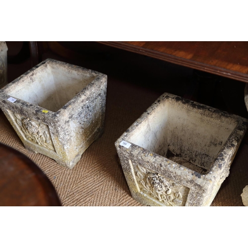 723 - A pair of carved stone garden planters with flower design, 14