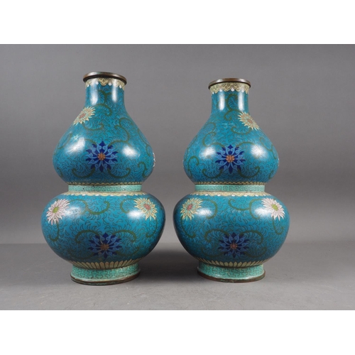 83 - A pair of Chinese cloisonne double gourd vases with floral, scrolled and Greek key designs, 11 1/4