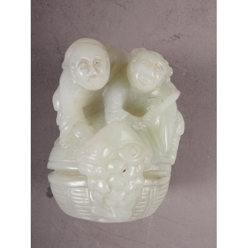 85 - A Chinese carved pale jade figure group, 2 1/2