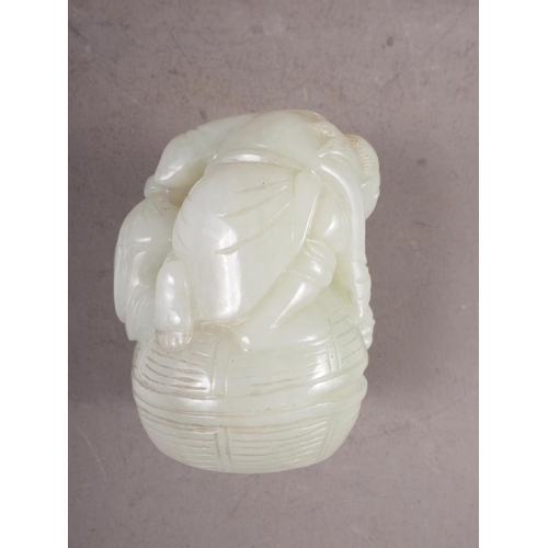 85 - A Chinese carved pale jade figure group, 2 1/2