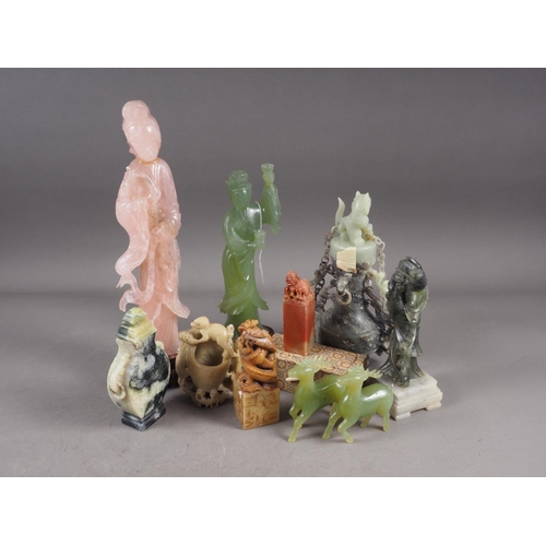 89 - A Chinese carved pink hardstone figure of Guanyin, on hardwood stand, a soapstone brush washer and o... 