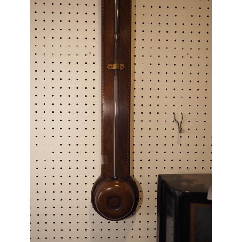 99 - An early 19th century walnut stick barometer with vernier by James Lillia