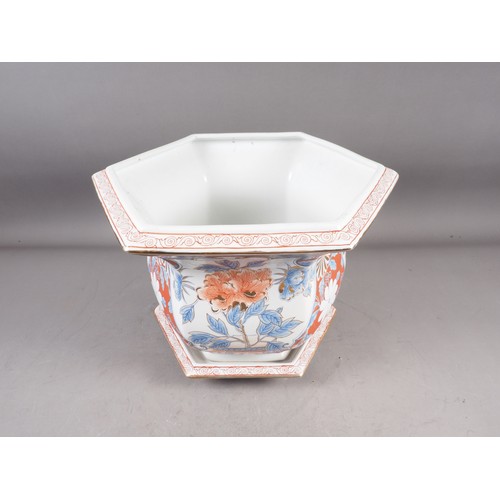 97 - A hexagonal jardiniere with floral decoration in the Imari palette and a matching saucer