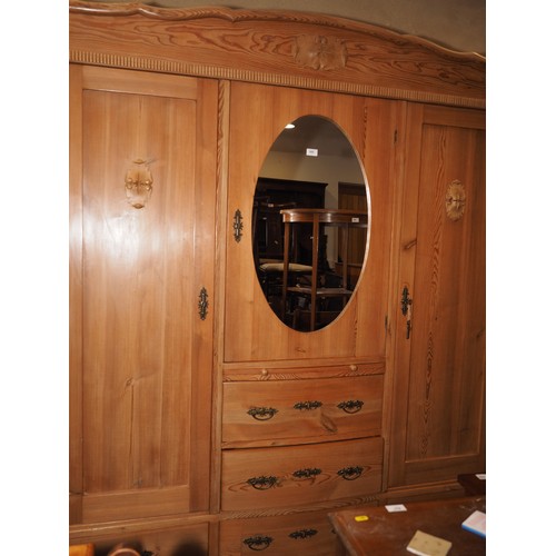 695 - An early 20th century Continental waxed pine break bowfront wardrobe, fitted two hanging compartment... 