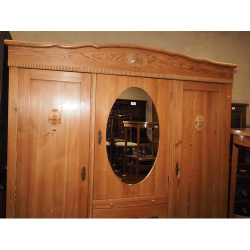 695 - An early 20th century Continental waxed pine break bowfront wardrobe, fitted two hanging compartment... 