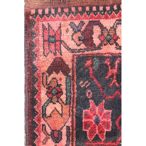 703 - A Bokhara rug with central medallion on a black ground and multi-bordered in traditional colours, 61... 