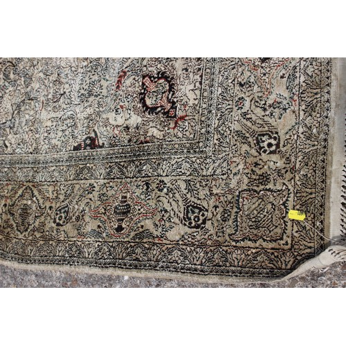 704 - A Kerman silken pile rug with all-over scroll and vase design on a light ground, 72