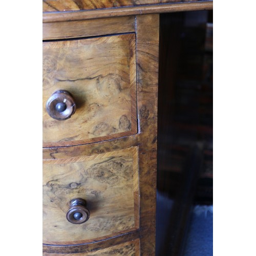 556 - A late 19th century figured walnut kidney-shaped double pedestal desk with tooled leather lined top,... 